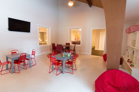 a dining room and living room with a table and chairs